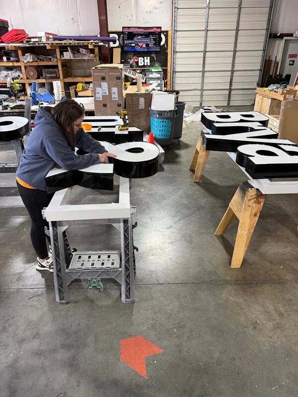 An image of signage being created in the warehouse.